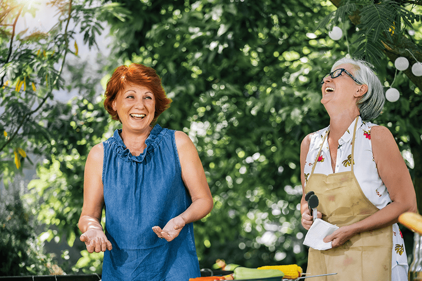 elderly people making barbeque, drinking beverages and making memories