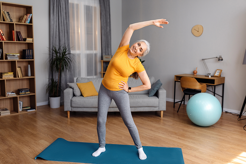 Happy senior woman having workout at home