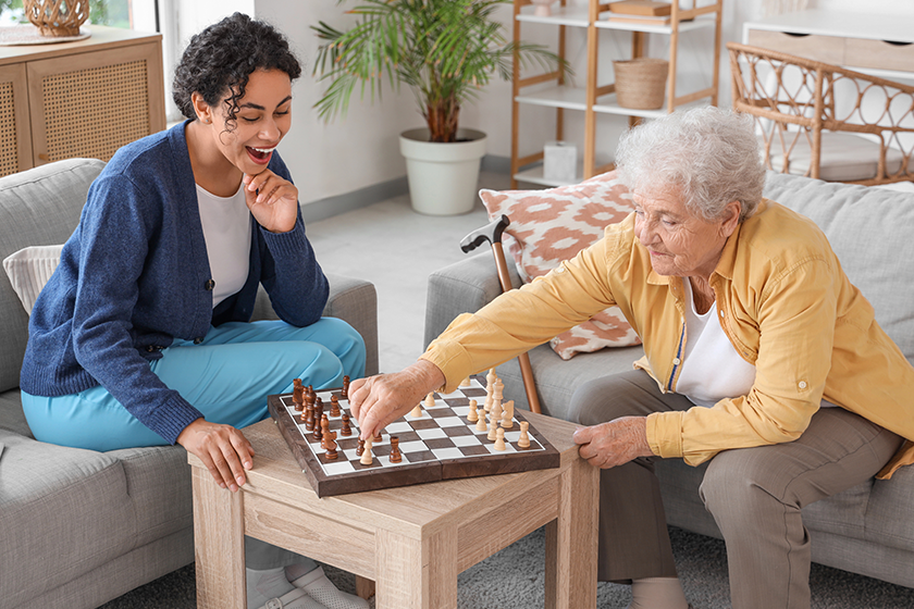 Young African-American female medical worker playing chess